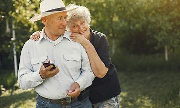 Beautiful old couple spend time in a summer garden